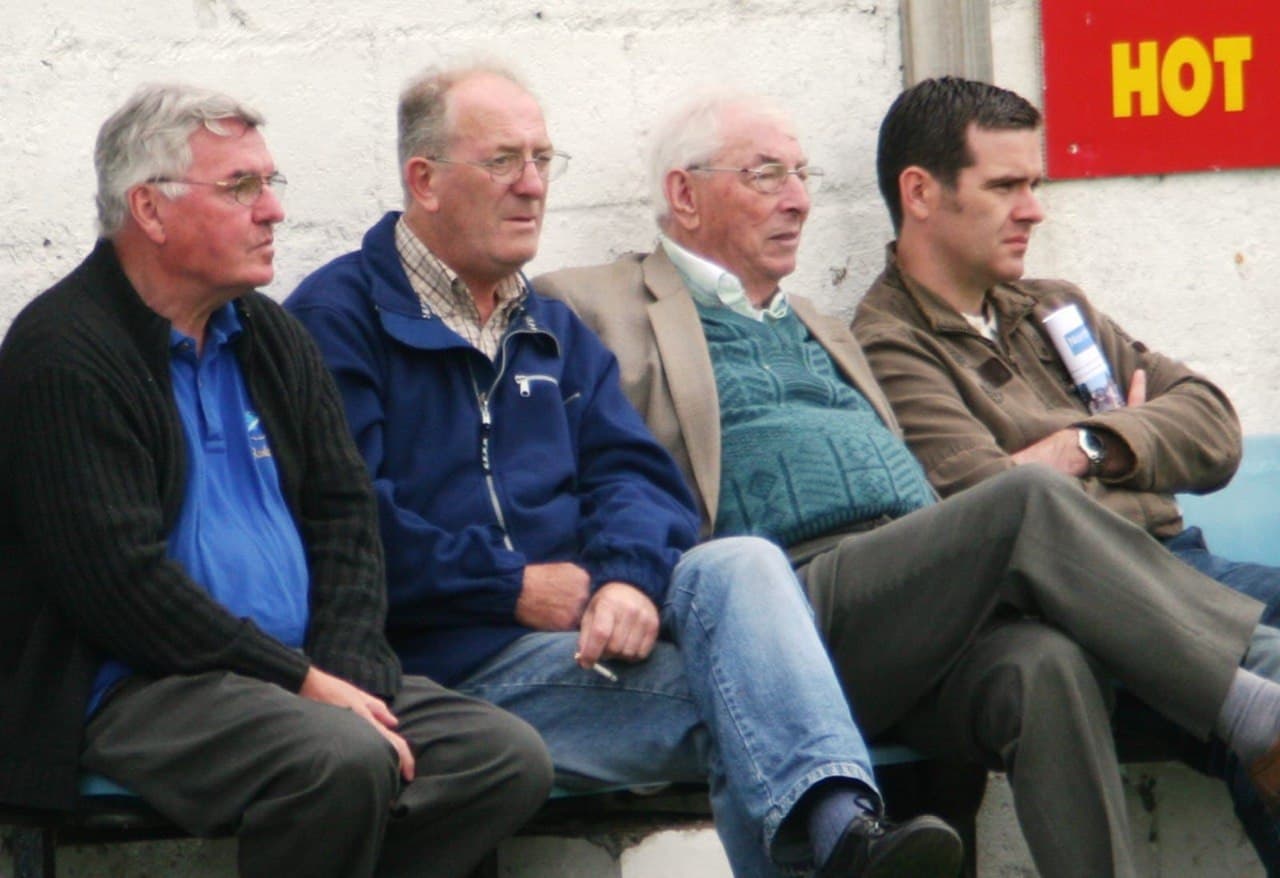 Club stalwarts watching from bench