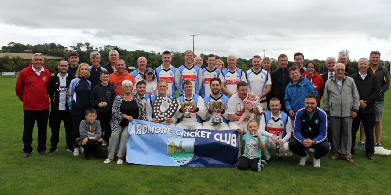 Double trophy winners with club banner