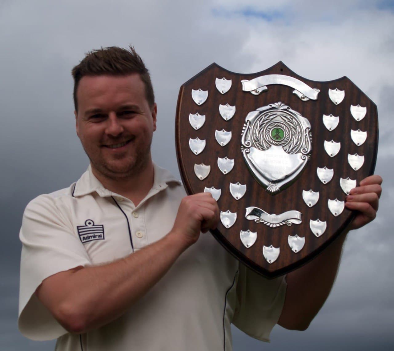 Player holding shield trophy